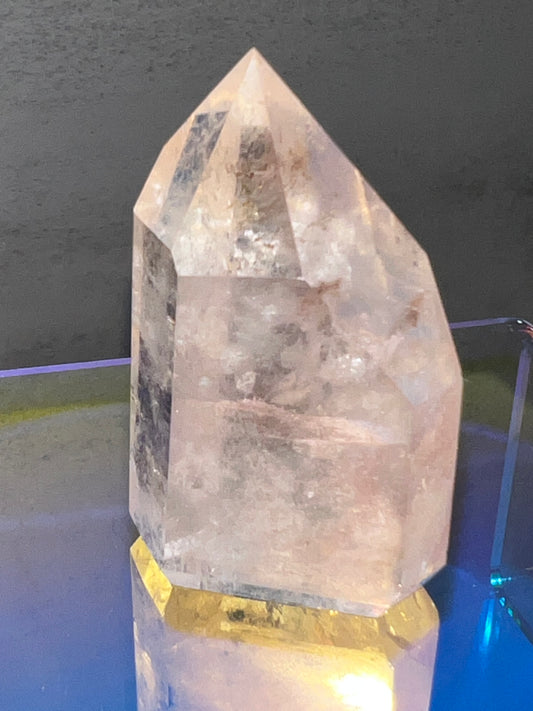 pink crystal in front of gray background