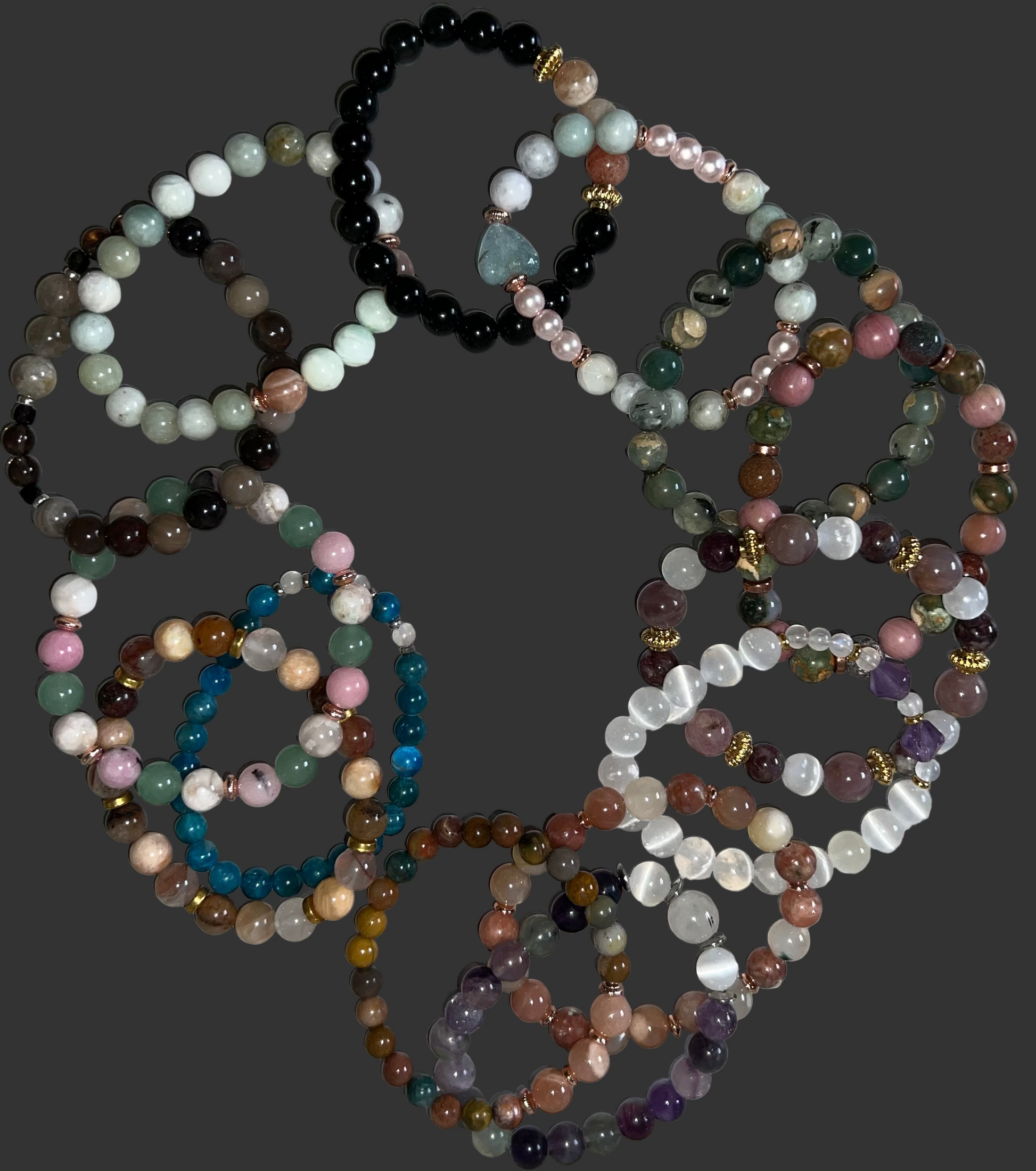Set of multicolored beaded bracelets on a textured surface