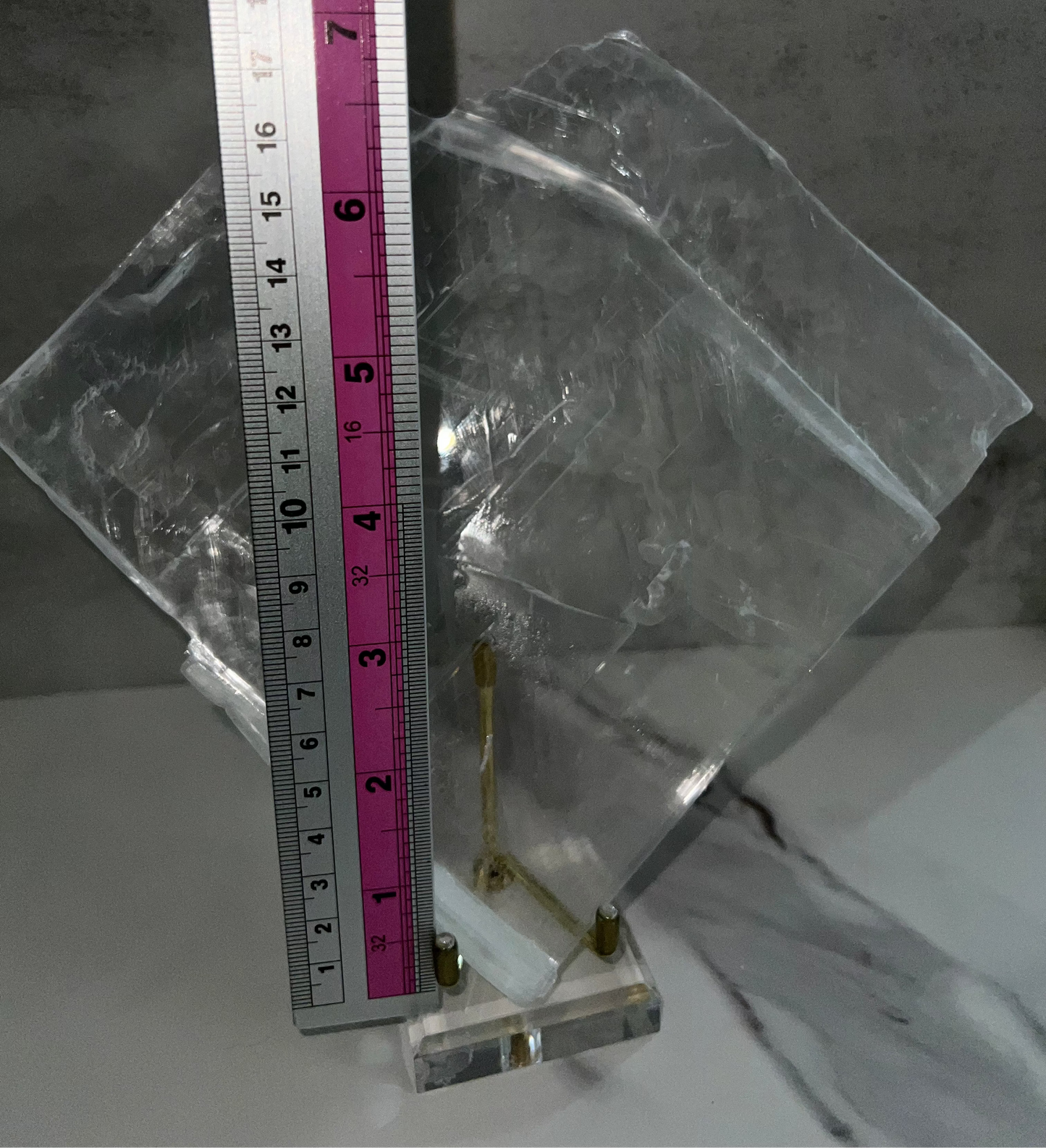Clear rectangular block with measurement ruler on a gray background